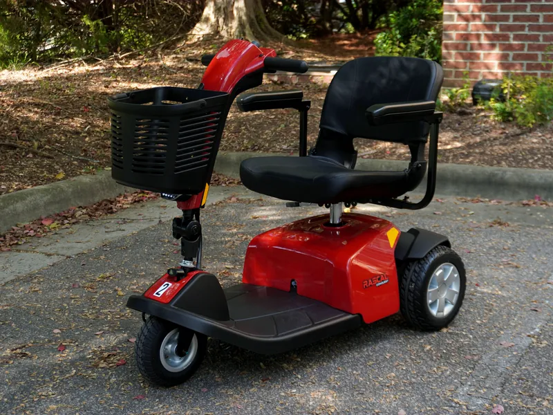 Red three-wheel mobility scooter with a front basket